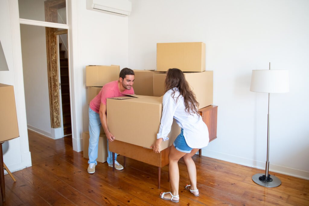 young family couple moving into new apartment