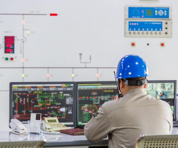 workers in control room of a factory.